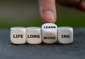 Hand turns dice and changes the expression `life long working` to ` life long learning`.