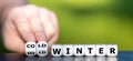 Hand turns dice and changes the expression `mild winter` to `cold winter`.