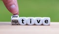 Hand turns a dice and changes the expression `negative` to `positive`. Royalty Free Stock Photo