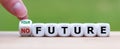 Hand turns a dice and changes the expression `no future` to `your future`. Royalty Free Stock Photo