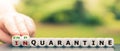 Hand turns dice and changes the expression `in quarantine` to `end quarantine`. Royalty Free Stock Photo