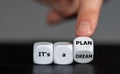 Hand turns dice and changes the expression `it`s a dream` to `it`s a plan. Royalty Free Stock Photo