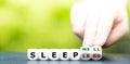 Hand turns dice and changes the expression `sleepless` to `sleep well`. Royalty Free Stock Photo