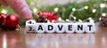 Hand turns dice and changes the expression \'third advent\' to \'fourth advent\'.