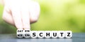 Hand turns dice and changes the German expression `kein Schutz` no protection to `Datenschutz` data privacy. Royalty Free Stock Photo