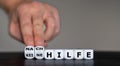 Hand turns dice and changes the German expression `keine Hilfe` no help to `Nachhilfe` private lessons. Royalty Free Stock Photo