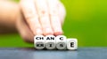 Hand turns dice and changes the German word `Krise` crisis to `Chance` chance. Royalty Free Stock Photo
