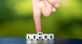Hand turns dice and changes the German word `Leere` emptiness to `Lehre` education. Royalty Free Stock Photo