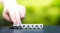 Hand turns dice and changes the word `antipathy` to `sympathy`. Royalty Free Stock Photo