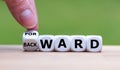 Hand turns a dice and changes the word `BACKWARD` to `FORWARD`. Royalty Free Stock Photo