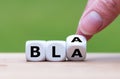 Hand turns a dice and changes the word `bla` to `bla