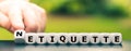 Hand turns dice and changes the word etiquette to netiquette