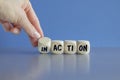 Hand turns a dice and changes the word Inactive to Active. Beautiful grey table blue background. Business and active or inactive Royalty Free Stock Photo