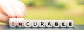 Hand turns dice and changes the word `incurable` to `curable`.