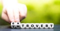 Hand turns dice and changes the word introvert to extrovert Royalty Free Stock Photo