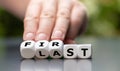 Hand turns dice and changes the word `last` to `first`. Royalty Free Stock Photo