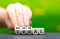 Hand turns dice and changes the word `legal` to `moral`. Royalty Free Stock Photo