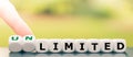 Hand turns dice and changes the word `limited` to `unlimited`.