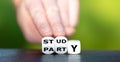 Hand turns dice and changes the word `party` to `study`. Royalty Free Stock Photo