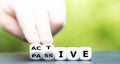 Hand turns dice and changes the word passive to active Royalty Free Stock Photo