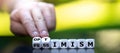 Hand turns dice and changes the word pessimism to optimism Royalty Free Stock Photo