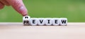 Hand turns a dice and changes the word `review` to `preview`. Royalty Free Stock Photo