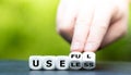Hand turns dice and changes the word `useless` to `useful`. Royalty Free Stock Photo