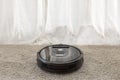 Hand turns on the round robot vacuum cleaner