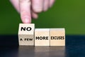 Hand turns a wooden cube and changes the expression \'a few more excuses\' to \'no more excuses Royalty Free Stock Photo