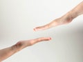 A hand of two persons reach to touch together on white background