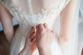 Hand tying the corset of the bride lace Royalty Free Stock Photo