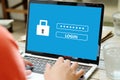Hand tying laptop computer with password login on screen, cyber