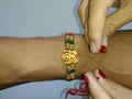 A hand tying rakhi on a hand wrist on the event of rakshabandhan Royalty Free Stock Photo