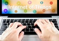 hand type on laptop with Internet of things (IoT) word and object icon and blur background, Digital Marketing concept Royalty Free Stock Photo