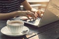 Hand typing on key board Laptop with cup of coffee Royalty Free Stock Photo