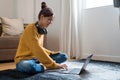 hand typing keyboard laptop online chatting search form internet while working sitting on floor.concept for work from Royalty Free Stock Photo