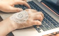 Hand Typing Laptop Keyboard. Woman Hand with Mandala Henna Art