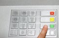 Hand typing the secret code in the keyboard of an ATM Royalty Free Stock Photo