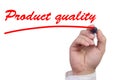 Hand underlining the words product quality in red