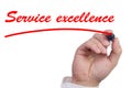 Hand underlining the words service excellence in red