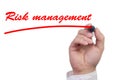 Hand underlining the work risk management in red