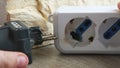 Hand unplug burnt power strip melted plastic for electrocution danger