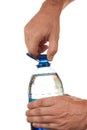 Hand unscrew the cork on a bottle of water