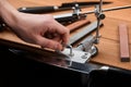 Hand unscrewing and loosening the machine after fine sharpening a Japanese knife