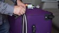 Hand Unzipping A Trolley Suitcase