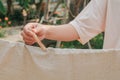 Ã Â¹â¡Hand use clothes pegs hanging fresh clean white towels on drying rack outdoor.Washing day housework with laundry.