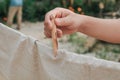 Ã Â¹â¡Hand use clothes pegs hanging fresh clean white towels on drying rack outdoor.Washing day housework with laundry. Royalty Free Stock Photo