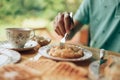 Hand use fork pick piece of fresh roti in plate. Roti and dessert concept