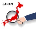 Hand use magnifying glass searching on japan map