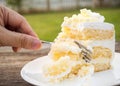 Hand used fork cut vanilla sponge cake with cream and white choc Royalty Free Stock Photo